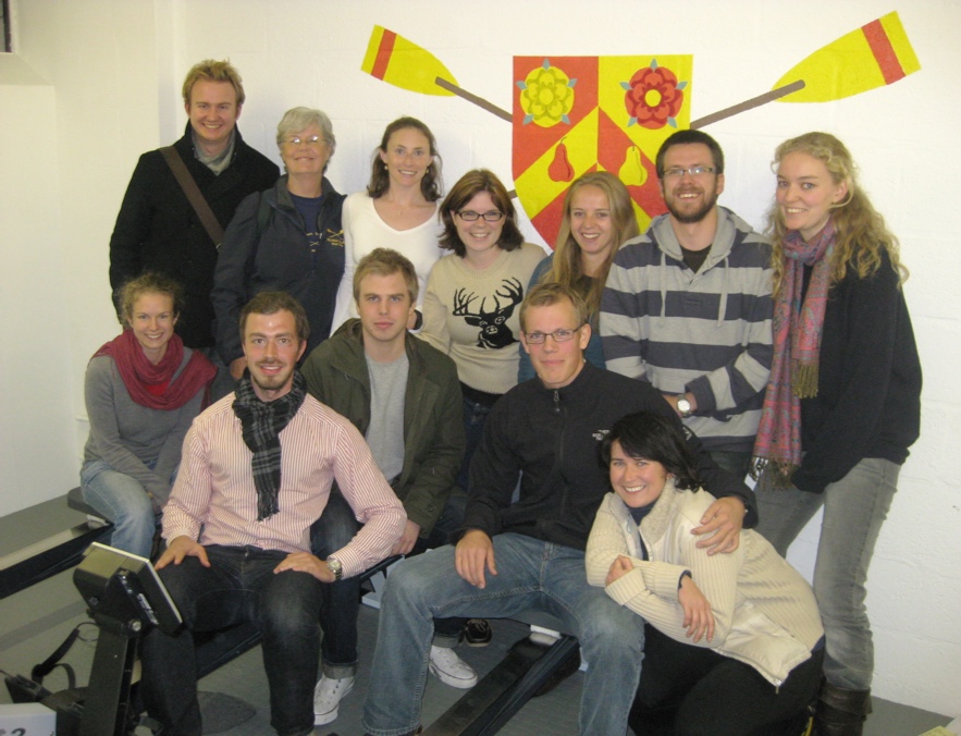 Members of the committee gather for the grand opening of the newly refurbished Wolfson erg room (Left to right, standing: Chris Prosser, Valerie Gorman, Amanda Reiner, Rebecca Schneider, Jill Betts, John Dale, Belinda Platt; seated: Aurélie Cuénod, Christian Bell, John Fluharty, Michael Lutteropp, Iana Alexeeva)